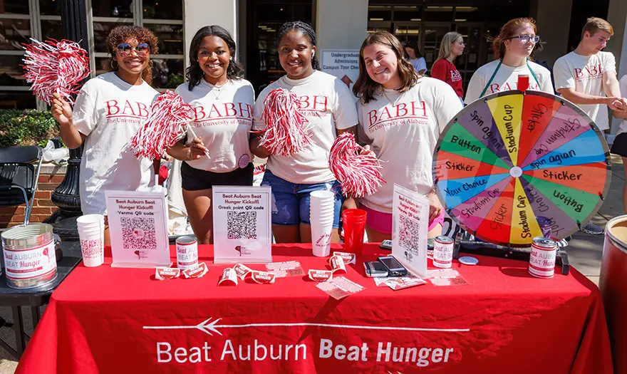 UA students wearing BABH T-shirts at the Beat Auburn Beat Hunger information and donation table on campus.