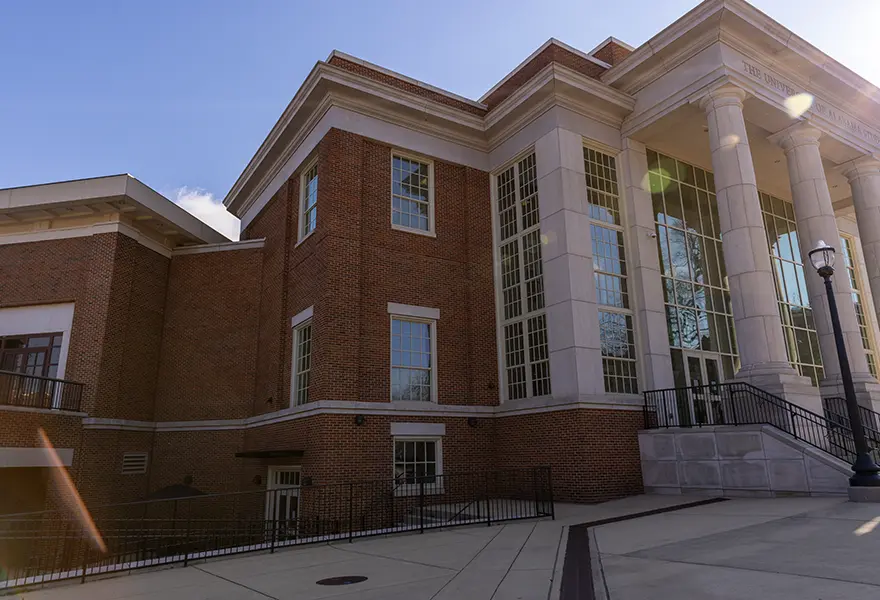 CSL entrance to the left of the UA Student Center south entrance with pillars and glass walls